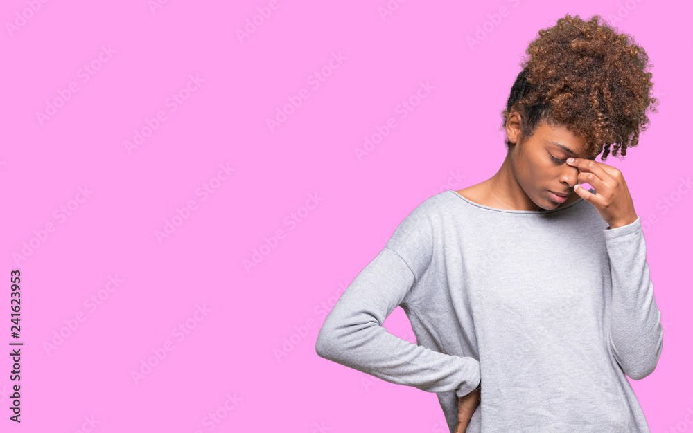 Beautiful young african american woman over isolated background tired rubbing nose and eyes feeling fatigue and headache. Stress and frustration concept. Beautiful young african american woman over isolated background tired rubbing nose and eyes feeling fatigue and headache. Stress and frustration concept.
