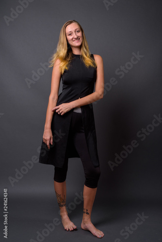 Full length portrait of young beautiful woman standing
