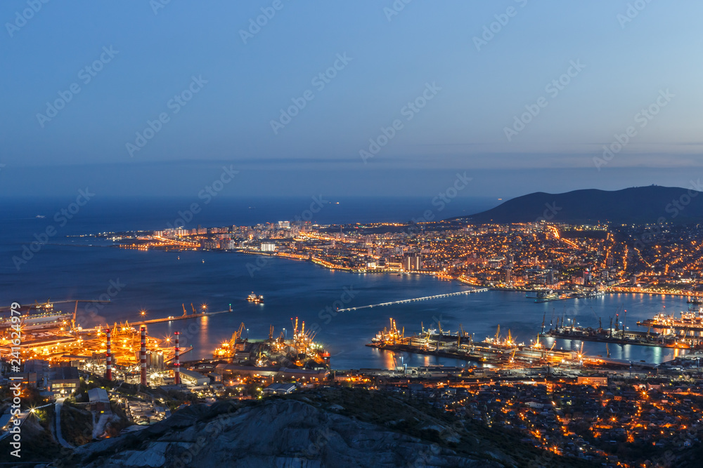 Panoramic view of Novorossiysk City and  Tsemess Bay. Night cityscape of large port at Black Sea coast in Russia