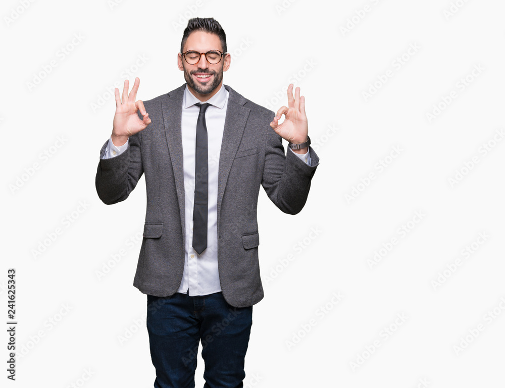 Young handsome business man over isolated background relax and smiling with eyes closed doing meditation gesture with fingers. Yoga concept. Young handsome business man over isolated background relax and smiling with eyes closed doing meditation gesture with fingers. Yoga concept.
