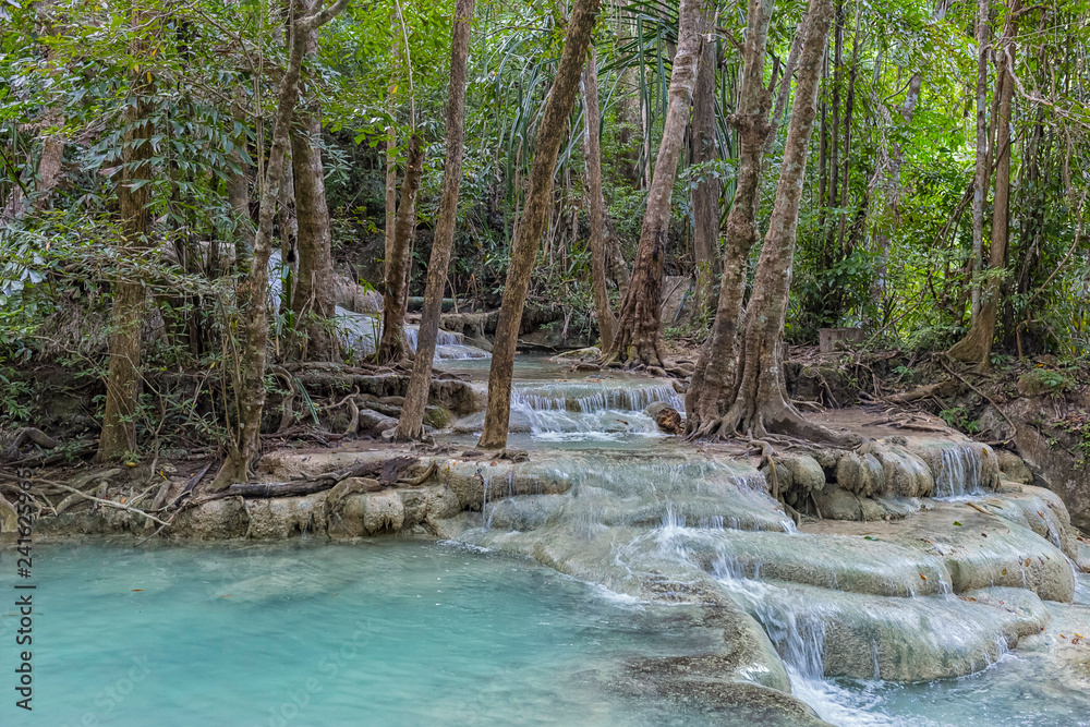 Naklejka premium Jangle landscape with flowing turquoise water of Erawan cascade waterfall