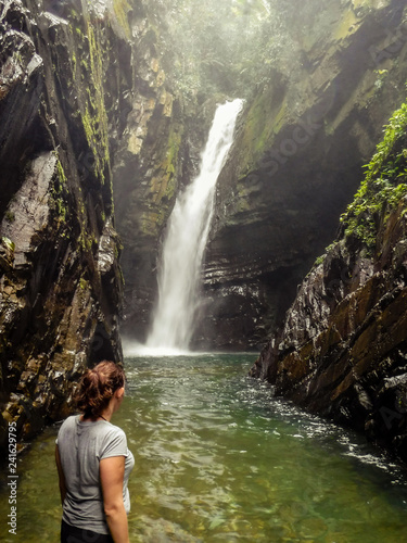 Woman contemplating the Andorinhas Waterfall, in Alto do Ribeira Tourist State Park (PETAR), Sao Paulo, Brazil