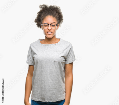 Young afro american woman wearing glasses over isolated background winking looking at the camera with sexy expression, cheerful and happy face.