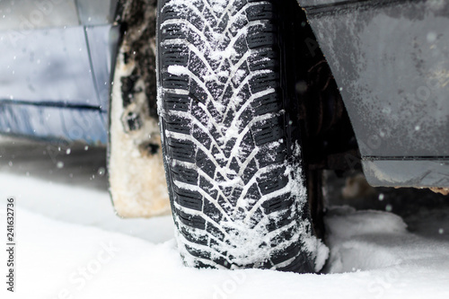 Winter is snowing. car wheel winter tires. close-up. have toning © sir270