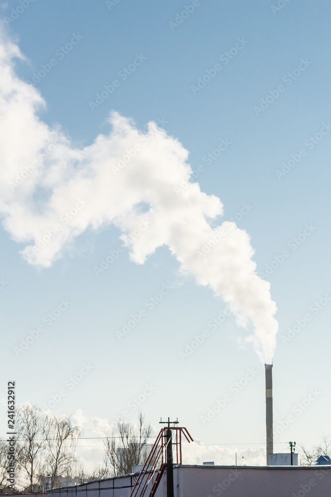 Clouds of smoke from the industrial chimney against sky. Air pollution, environmental issues.