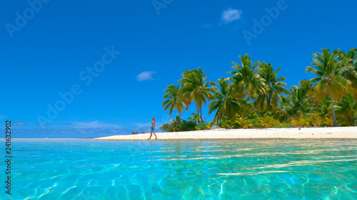 LOW ANGLE: Unrecognizable young woman observing the endless turquoise ocean.