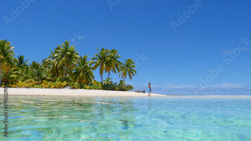 LOW ANGLE  Girl enjoying a stroll around a tropical isle in the tranquil Pacific