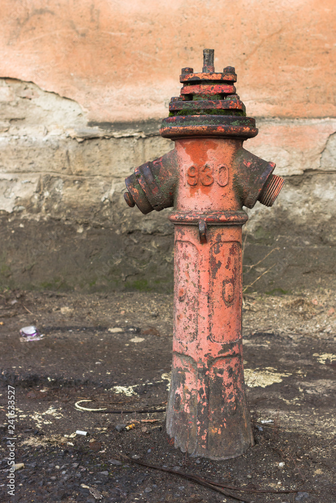 Red hydrant on the street. Fire extinguishing agent. Pipe with water. Fire system in the old days. Old hydrant. Fire safety. Red hydrant on the street. Fire extinguishing agent. Pipe with water. Fire system in the old days. Old hydrant. Fire safety.