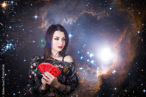 beautiful fortune teller wondering on the Tarot cards. Predicting the future, access to the astral