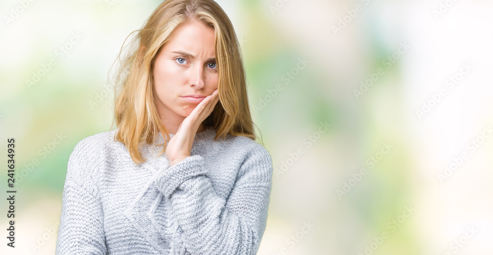 Beautiful young woman wearing winter sweater over isolated background thinking looking tired and bored with depression problems with crossed arms.