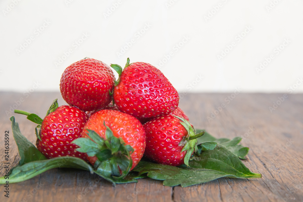 Fresh red strawberry on wood background