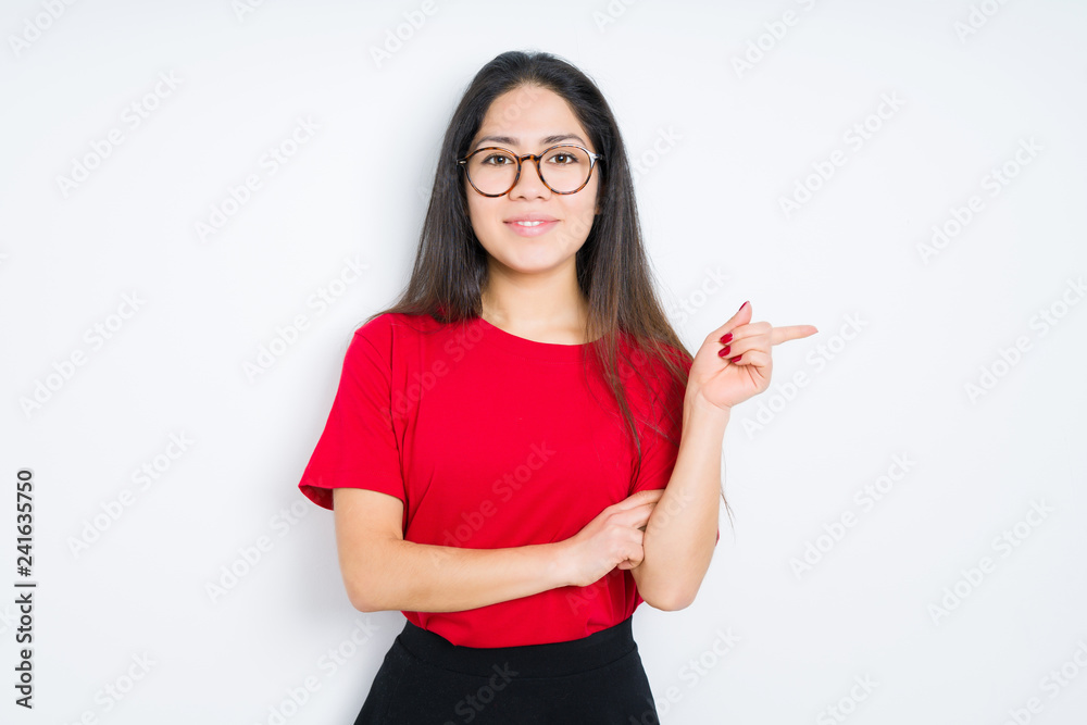 Beautiful brunette woman wearing glasses over isolated background with a big smile on face, pointing with hand and finger to the side looking at the camera. Beautiful brunette woman wearing glasses over isolated background with a big smile on face, pointing with hand and finger to the side looking at the camera.