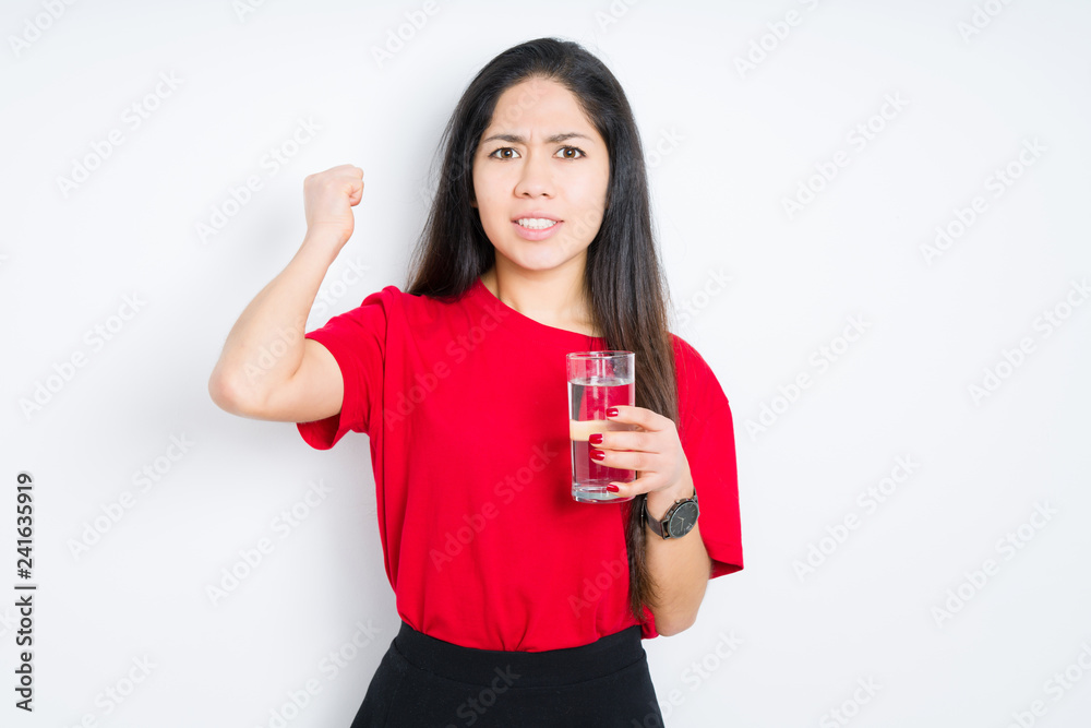 Young brunette woman drinking a glass of water over isolated background annoyed and frustrated shouting with anger, crazy and yelling with raised hand, anger concept Young brunette woman drinking a glass of water over isolated background annoyed and frustrated shouting with anger, crazy and yelling with raised hand, anger concept