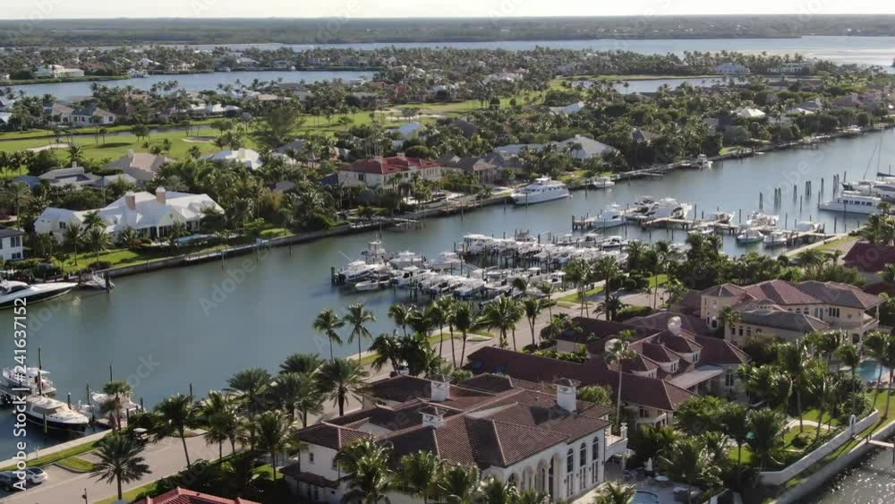Aerial of luxury homes lining Port St. Lucie's waterfront, with views of private boat docks, golf courses and the Atlantic Ocean. Aerial of luxury homes lining Port St. Lucie's waterfront, with views of private boat docks, golf courses and the Atlantic Ocean.