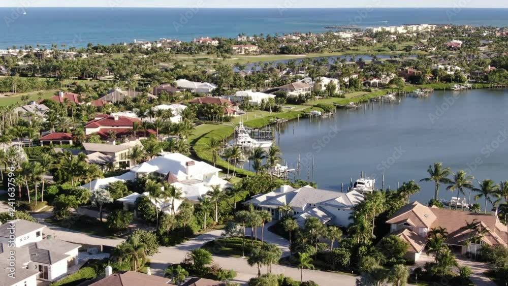 Aerial of luxury homes lining Port St. Lucie's waterfront, with views of private boat docks, golf courses and the Atlantic Ocean. Aerial of luxury homes lining Port St. Lucie's waterfront, with views of private boat docks, golf courses and the Atlantic Ocean.