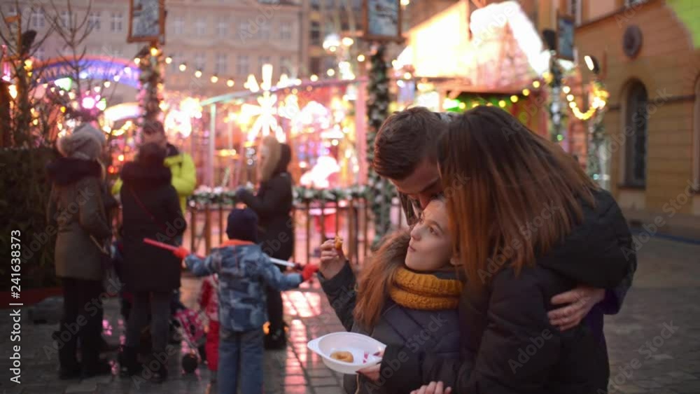 Happy Family with Daughter make Phone Photo on a Christmas Lights City Street Happy Family with Daughter make Phone Photo on a Christmas Lights City Street