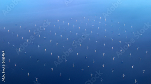 Windmills at the sea. Clean energy made by the wind. photo