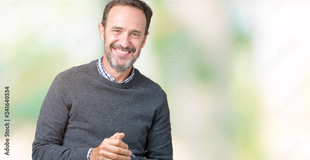 Handsome middle age senior man wearing a sweater over isolated background Hands together and fingers crossed smiling relaxed and cheerful. Success and optimistic Handsome middle age senior man wearing a sweater over isolated background Hands together and fingers crossed smiling relaxed and cheerful. Success and optimistic