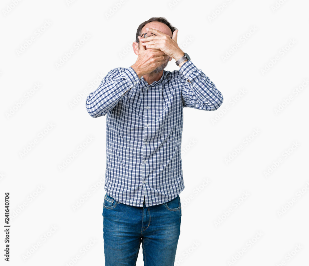 Handsome middle age elegant senior man wearing glasses over isolated background Covering eyes and mouth with hands, surprised and shocked. Hiding emotion Handsome middle age elegant senior man wearing glasses over isolated background Covering eyes and mouth with hands, surprised and shocked. Hiding emotion