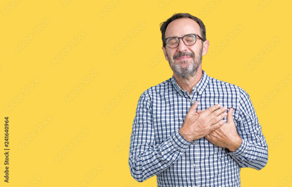 Handsome middle age elegant senior business man wearing glasses over isolated background smiling with hands on chest with closed eyes and grateful gesture on face. Health concept. Handsome middle age elegant senior business man wearing glasses over isolated background smiling with hands on chest with closed eyes and grateful gesture on face. Health concept.