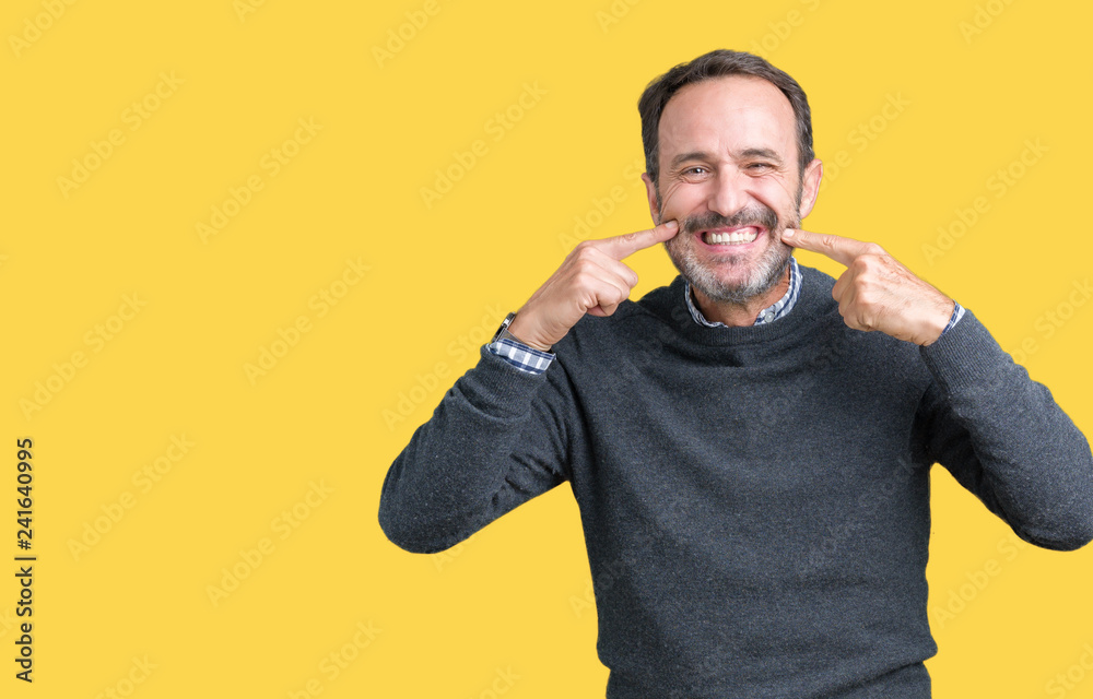 Handsome middle age senior man wearing a sweater over isolated background smiling confident showing and pointing with fingers teeth and mouth. Health concept. Handsome middle age senior man wearing a sweater over isolated background smiling confident showing and pointing with fingers teeth and mouth. Health concept.