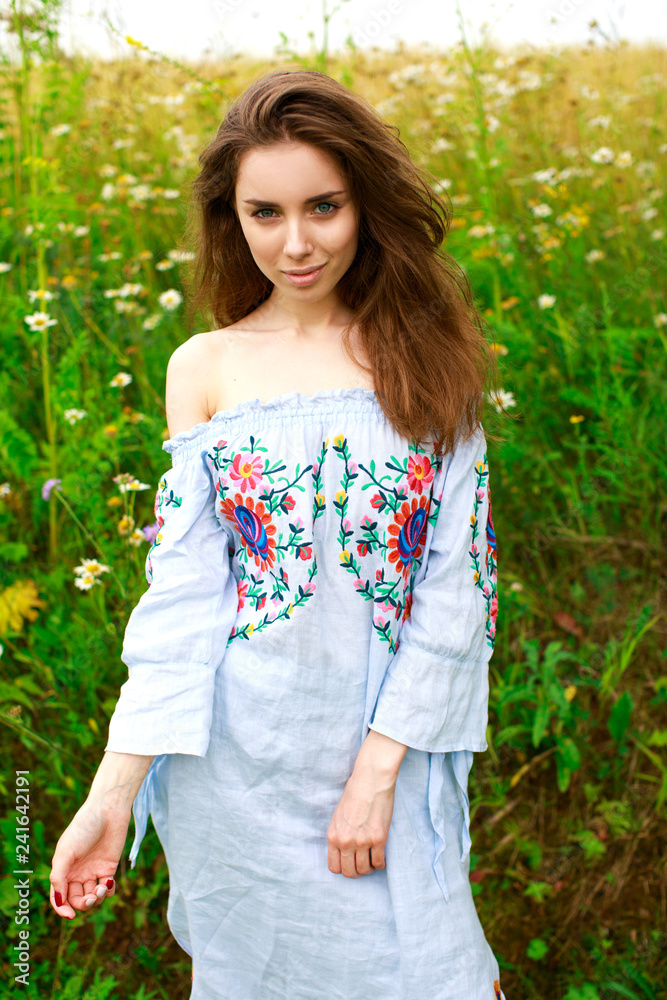 Brunette woman on a background chamomile field Brunette woman on a background chamomile field