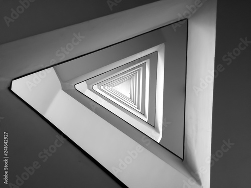 Black and white triangle infinite spiral pattern minimal modern architecture staircase abstract spiritual symbol	