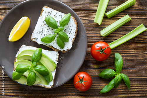 Tasty vegetarian avocado sandwiches on rustic table.