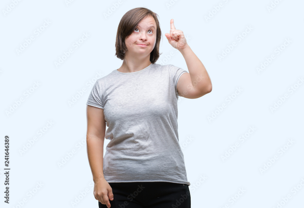 Young adult woman with down syndrome over isolated background pointing finger up with successful idea. Exited and happy. Number one. Young adult woman with down syndrome over isolated background pointing finger up with successful idea. Exited and happy. Number one.