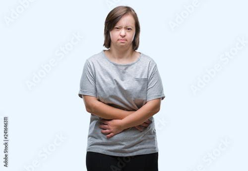 Young adult woman with down syndrome over isolated background with hand on stomach because indigestion, painful illness feeling unwell. Ache concept.