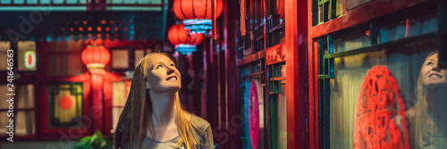 Young woman tourist looks at the Chinese traditional lanterns. Chinese New Year. Travel to China concept BANNER, LONG FORMAT