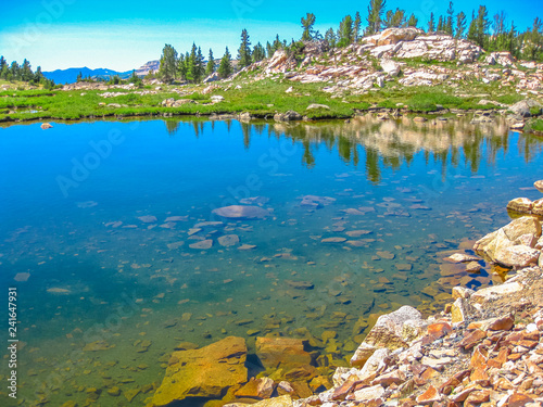Clear waters of Alpine lake along Beartooth Highway, Northeast gateway of Yellowstone National Park. Beartooth Highway, the most beautiful drive in America, section of Route 212, Montana and Wyoming. photo