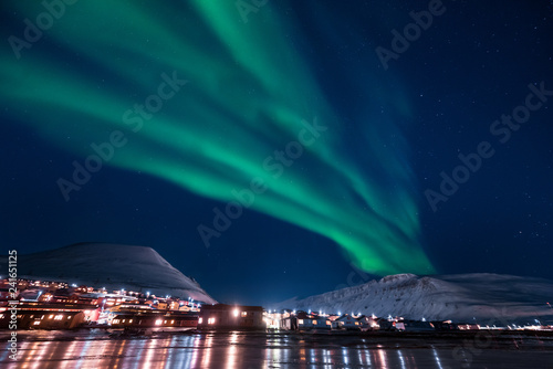 The polar arctic Northern lights aurora borealis sky star in Norway Svalbard in Longyearbyen the moon mountains