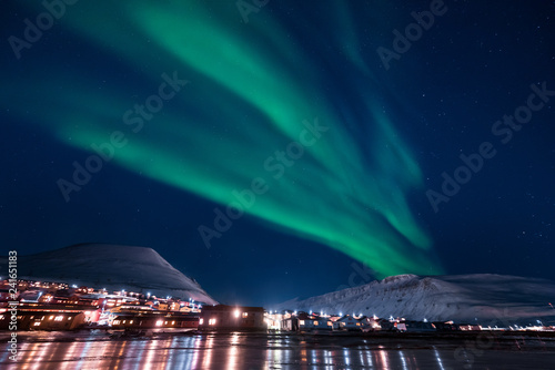 The polar arctic Northern lights aurora borealis sky star in Norway Svalbard in Longyearbyen the moon mountains photo