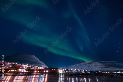 The polar arctic Northern lights aurora borealis sky star in Norway Svalbard in Longyearbyen the moon mountains