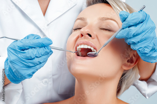 Dentist examining a patient's teeth in the dentis.