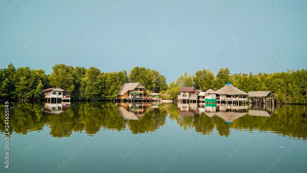 Beautiful landscapes with huts and reflection on lake in the morning day.