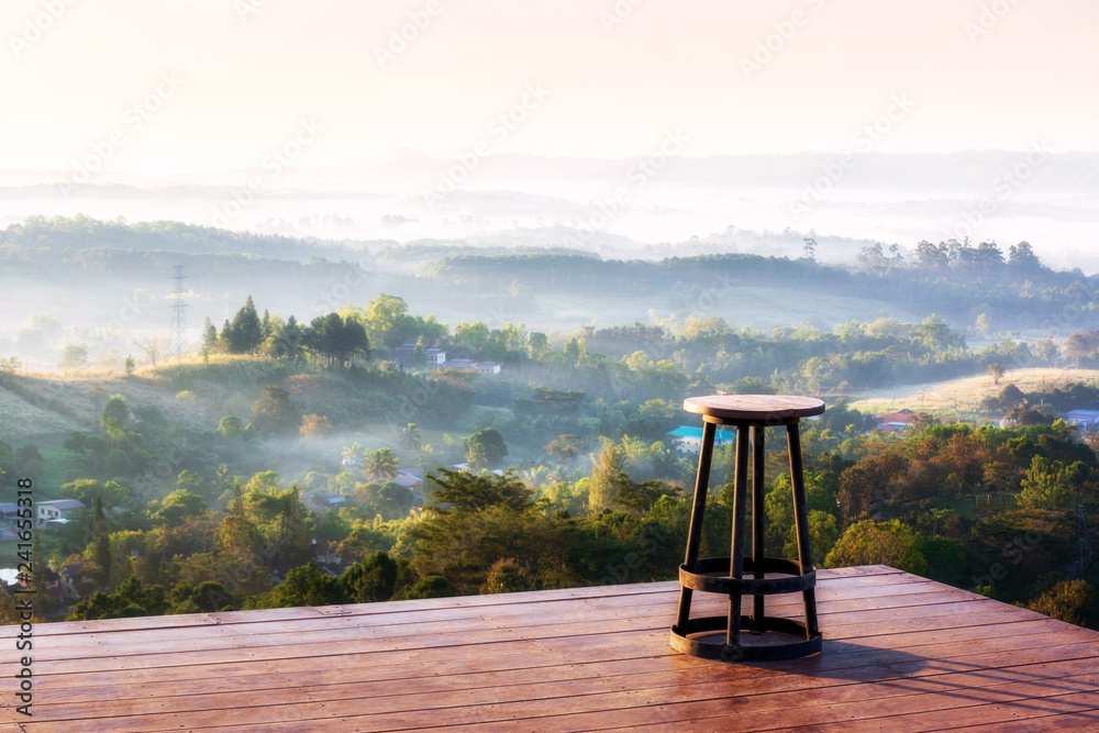 A Chair on the hill top therefore sitting and take view sunrise of Khao-Kho Mountain range over with cloudy fog, the famous place in Petchaboon Thailand A Chair on the hill top therefore sitting and take view sunrise of Khao-Kho Mountain range over with cloudy fog, the famous place in Petchaboon Thailand