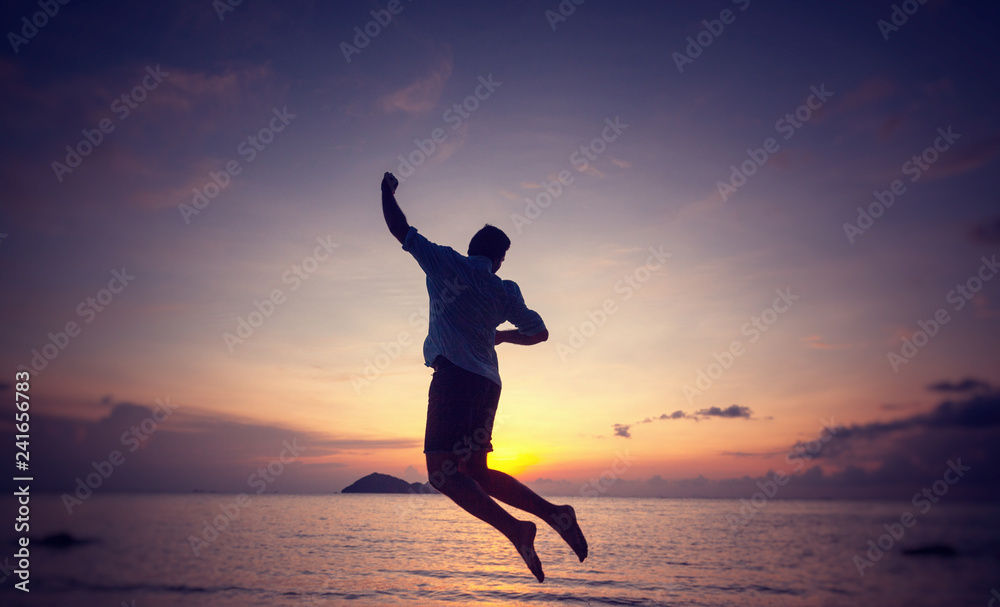 Silhouette of a jumping man on the seashore at sunset, man and nature concept, beauty lifestyle freedom vacation travel Silhouette of a jumping man on the seashore at sunset, man and nature concept, beauty lifestyle freedom vacation travel
