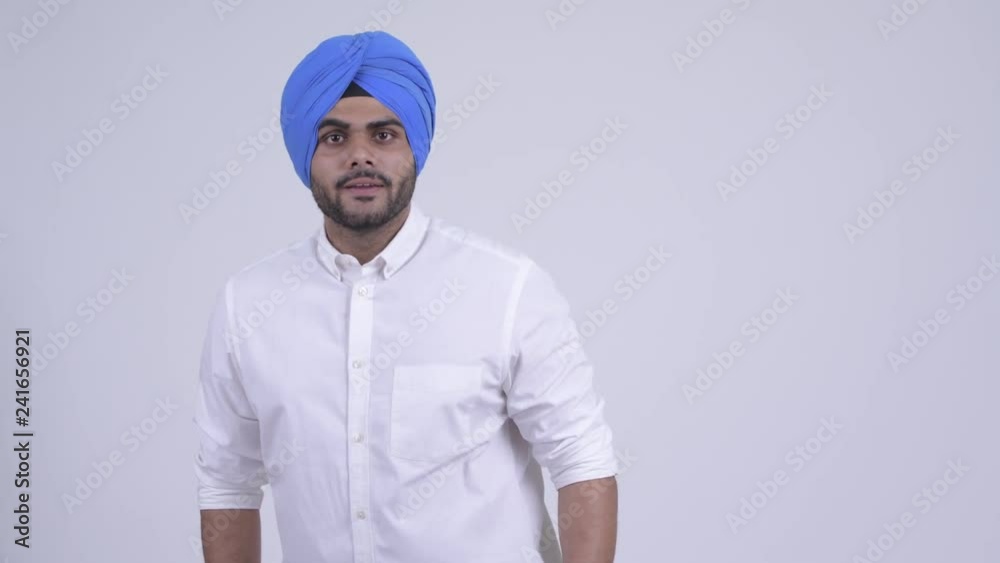 Angry young bearded Indian Sikh man talking aggressively and pointing at camera Angry young bearded Indian Sikh man talking aggressively and pointing at camera
