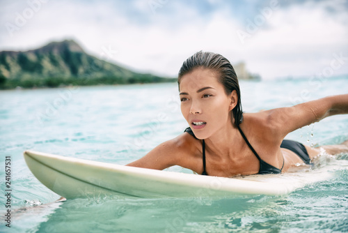 Surfing Asian woman surfer on lesson in paddling on surfboard in ocean. Sexy sports training in water. Watersport active lifestyle. foto de Stock | Adobe Stock