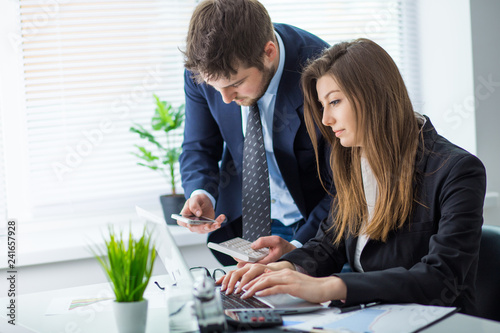 Young businessman discussing something with his colleague