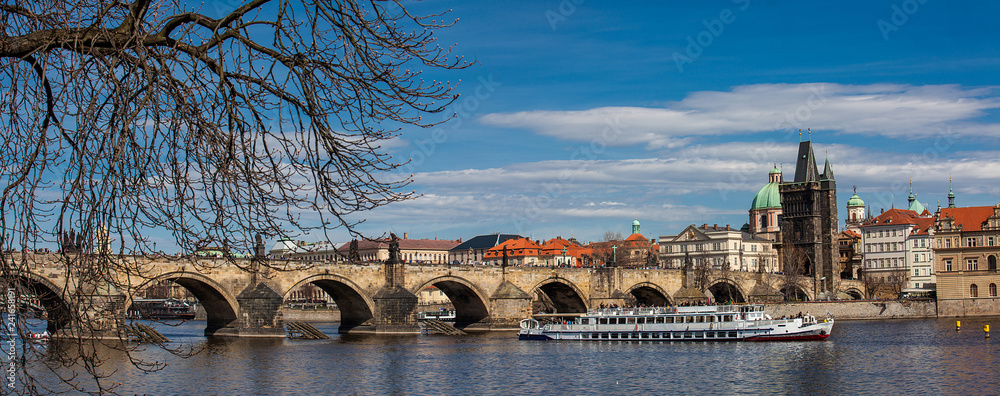The beautiful old town of Prague city, the Vltava river and the iconic Charles bridge seen from Kampa park