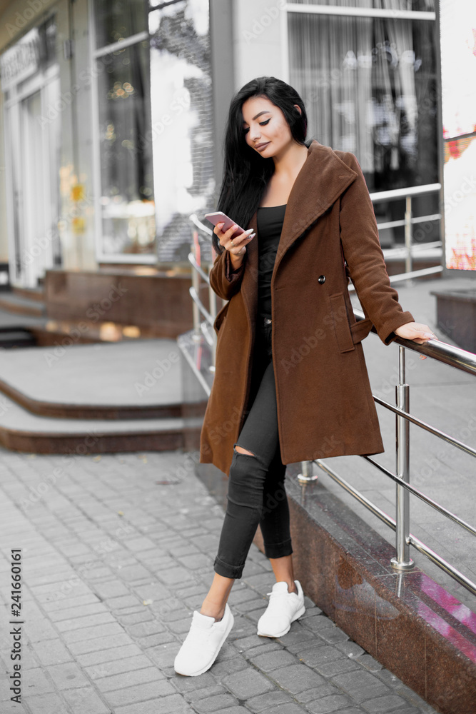 Beautiful woman using the phone on the street. Beautiful woman using the phone on the street.