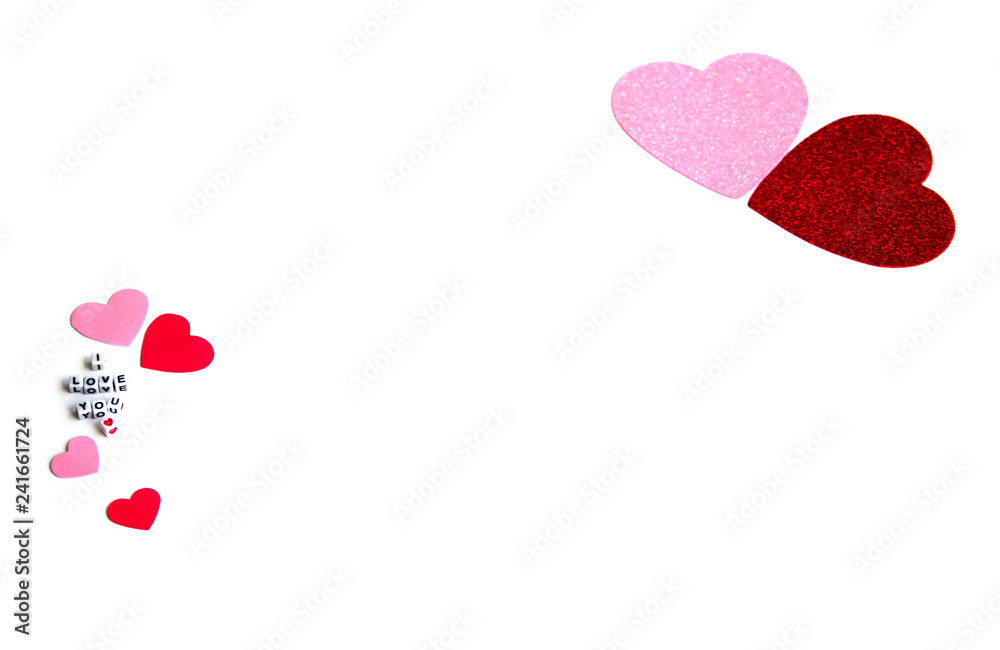 Phrase I Love You constructed from white letter cubes, Pink and Red Hearts on a White Background. Romance Valentine Mother's Day concept. .