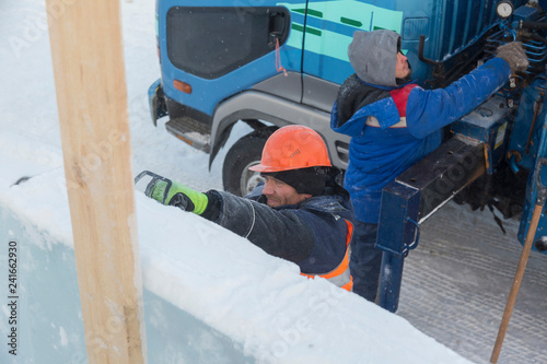 Worker on the installation of an ice panel
