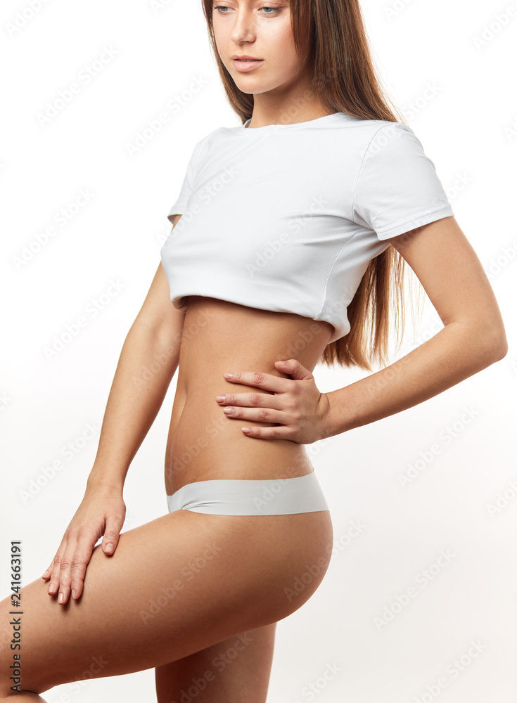 Long haired young woman wearing cotton panties and white top . profile view close  up. Female underwear made from natural organic materials Stock-bilde