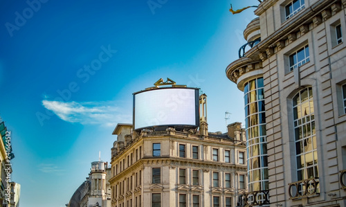 A large digital display board on top of a building in london near piccadilly photo