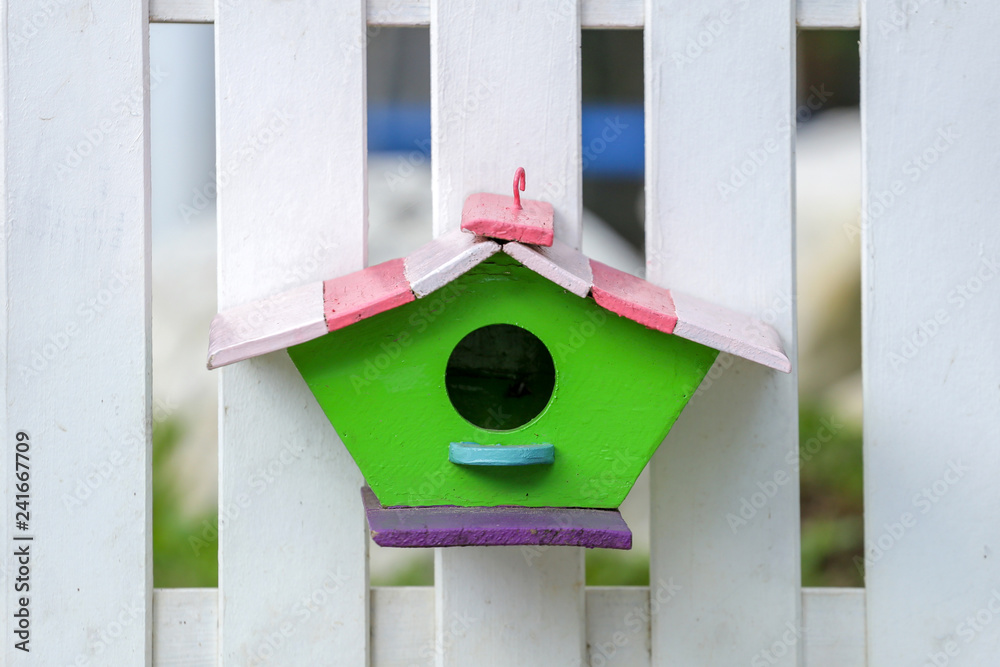 cute little birdhouses on rustic wooden fence