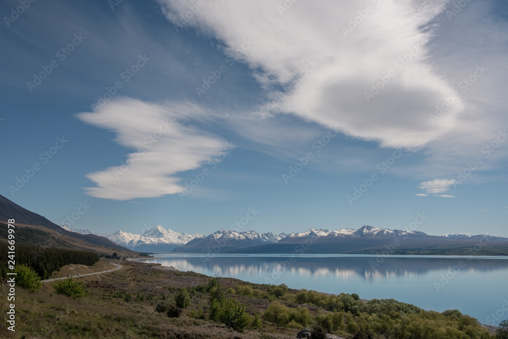 The view up the turquoise coloured water of Lake Pukaki to Mount Cook on a clear, calm morning. Canterbury, New Zealand.